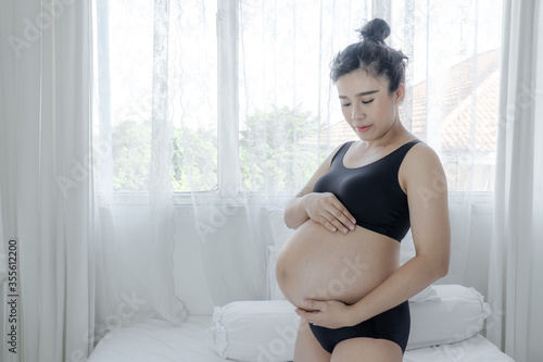 pregnant woman touching her belly with hands Free Download pregnant woman touching her belly with hands - GFXLoad