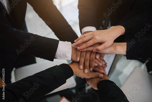 Business teamwork and women shake hands confidently at an office meeting.