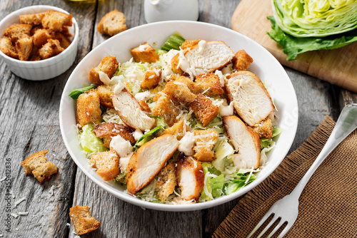 Fényképezés Classic caesar salad with grilled chicken fillet and parmesan cheese