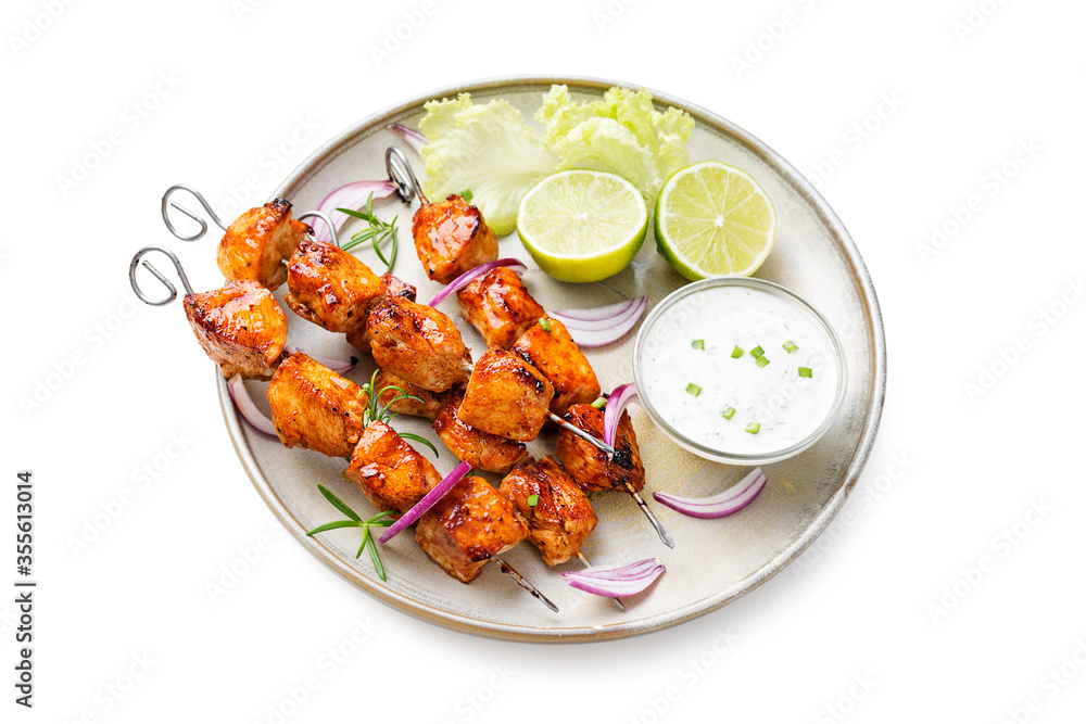 Kebabs - grilled chicken meat skewers, shish kebab with green salad leaves isolated on white background Kebabs - grilled chicken meat skewers, shish kebab with green salad leaves isolated on white background
