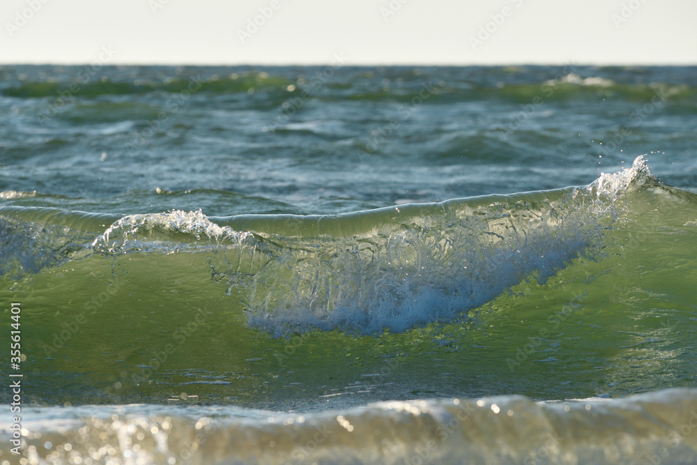 Obraz premium Sea or ocean, waves close-up view. Green - yellow waves sea water.