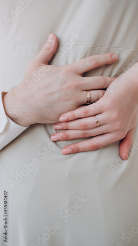 beautiful hand of a girl with a ring on her finger embraces a man