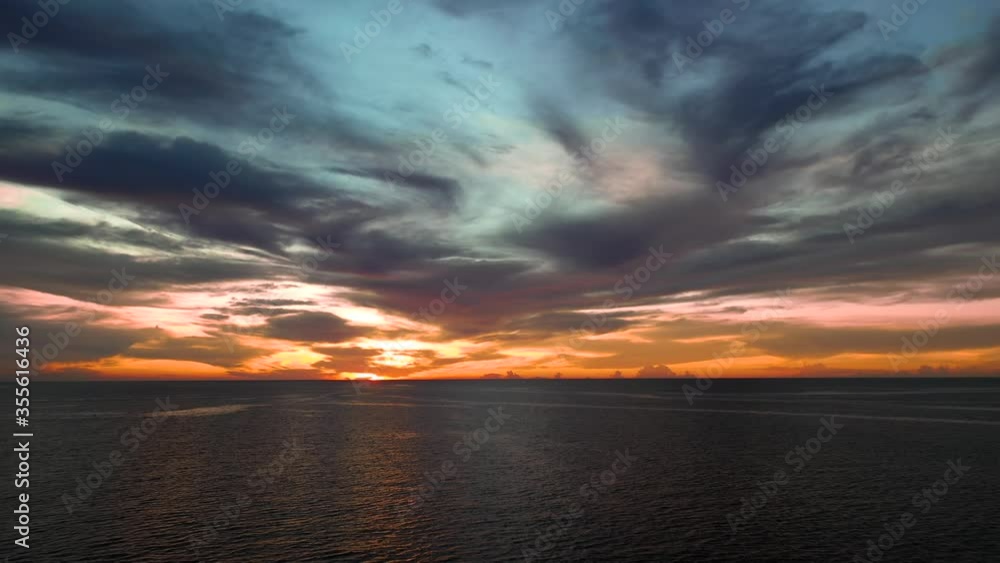 Dramatic clouds at sunset above the ocean, forward aerial Dramatic clouds at sunset above the ocean, forward aerial