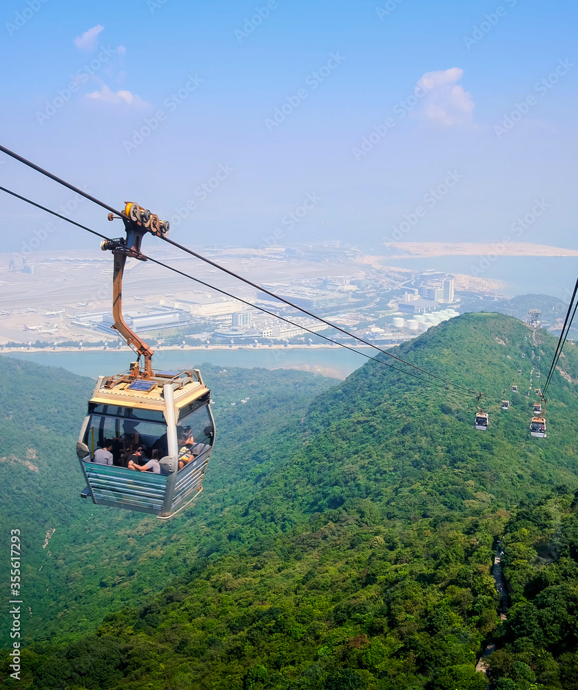 Skyline cable car with green mountains and ocean landscape background