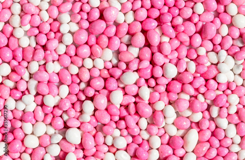 Close up of pink and white glazed anise seeds, called 