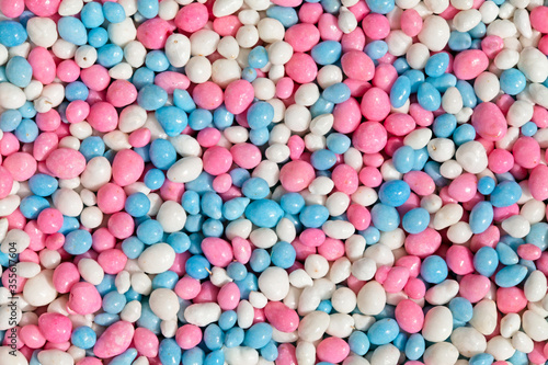 Close up of blue, pink and white glazed anise seeds, called "muisjes". This is the LGBT version of the traditional topping on a biscuit served to celebrate the birth of a baby in the Netherlands.  