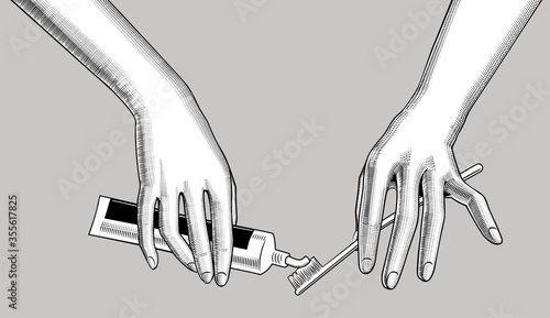 Engraved drawing of hands squeeze toothpaste onto a toothbrush