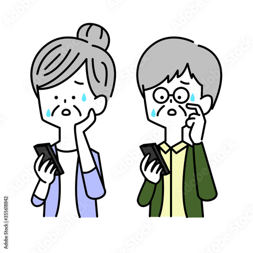 スマホを見て困惑する男女