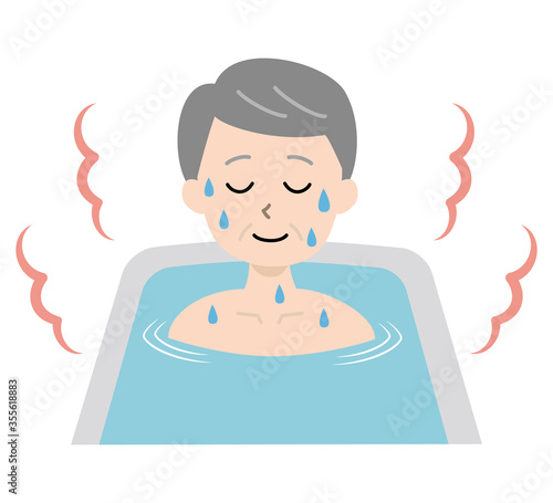 お風呂で湯船に浸かって汗をかく高齢男性