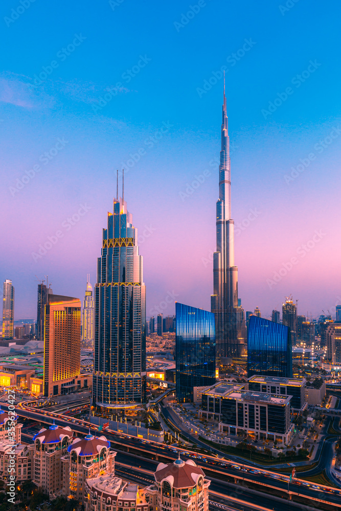 Downtown Dubai during amazing purple sunset with the world's tallest building, the world's largest mall and adjoining luxury hotels