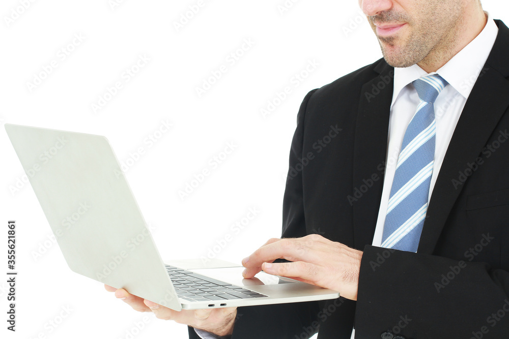 Close up handsome businessman in a suit hand holding notebook and working on a laptop isolated on white background Close up handsome businessman in a suit hand holding notebook and working on a laptop isolated on white background