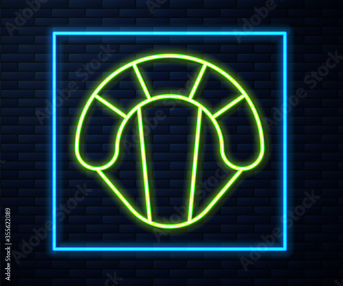 Glowing neon line Parachute icon isolated on brick wall background. Extreme sport. Sport equipment. Vector Illustration.