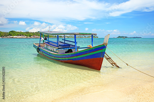 Colorful boat on a tropical island in Belitung, Indonesia. © LilyRosePhotos