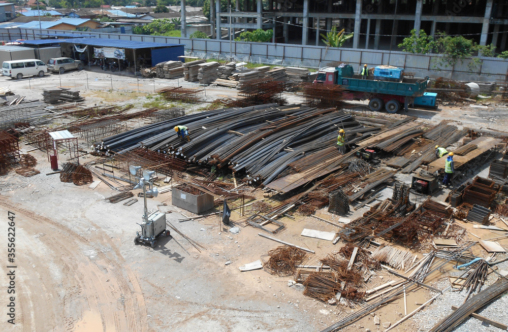 SELANGOR, MALAYSIA -AUGUST 05, 2016: Construction workers working at the steel reinforcement bar bending yard in the construction site.