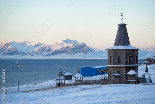 Russian church with snow covered landscape in an old mining town called 