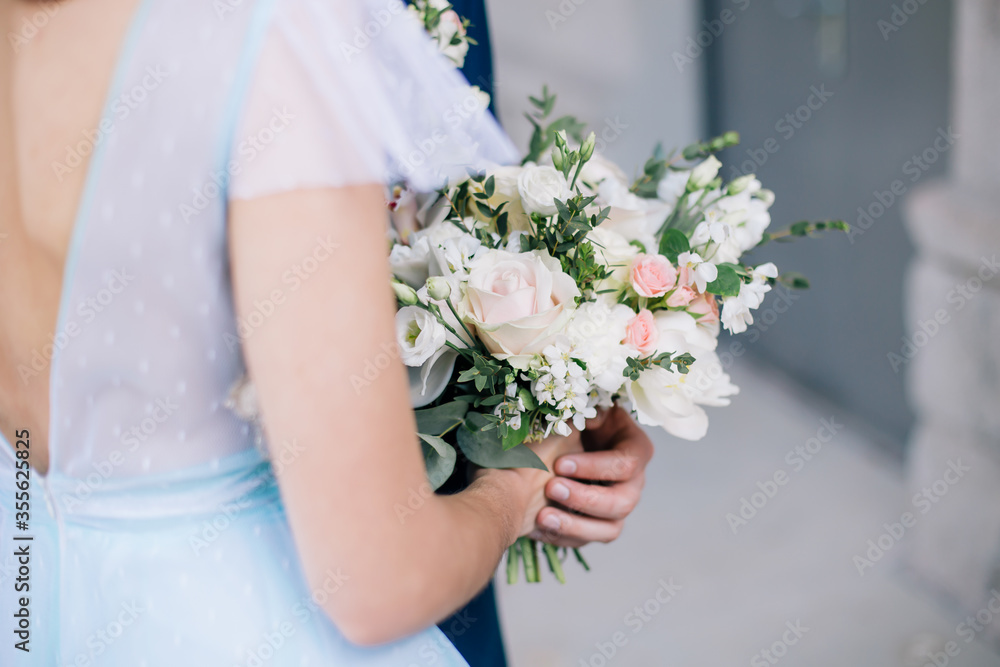 Wedding bouquet in the hands of the bride Wedding bouquet in the hands of the bride