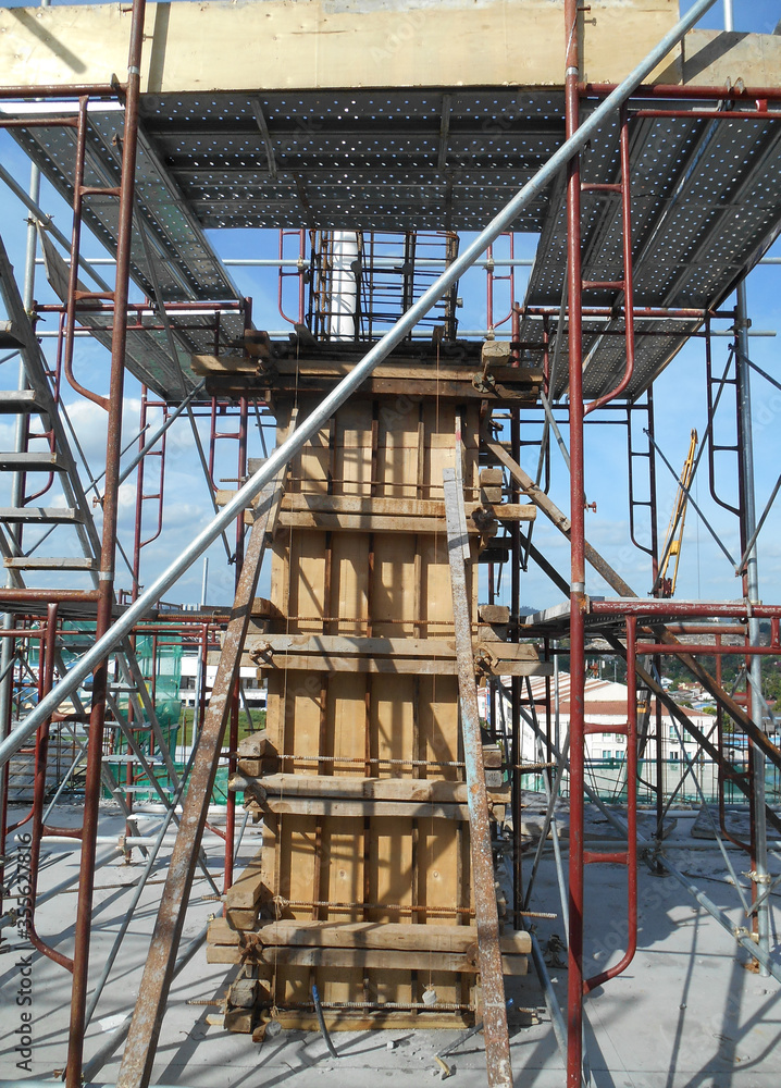 MALACCA, MALAYSIA -SEPTEMBER 19, 2016: Column timber form work and reinforcement bar at the construction site in Malacca, Malaysia. The structure supported by temporary wood support MALACCA, MALAYSIA -SEPTEMBER 19, 2016: Column timber form work and reinforcement bar at the construction site in Malacca, Malaysia. The structure supported by temporary wood support