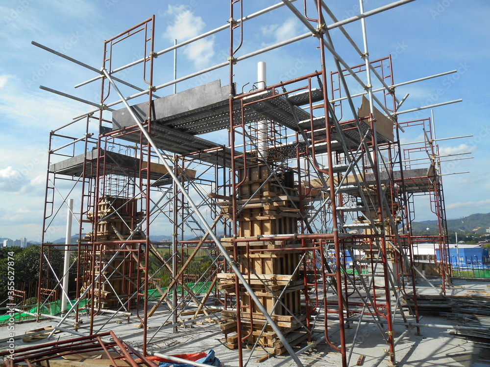 MALACCA, MALAYSIA -SEPTEMBER 19, 2016: Column timber form work and reinforcement bar at the construction site in Malacca, Malaysia. The structure supported by temporary wood support