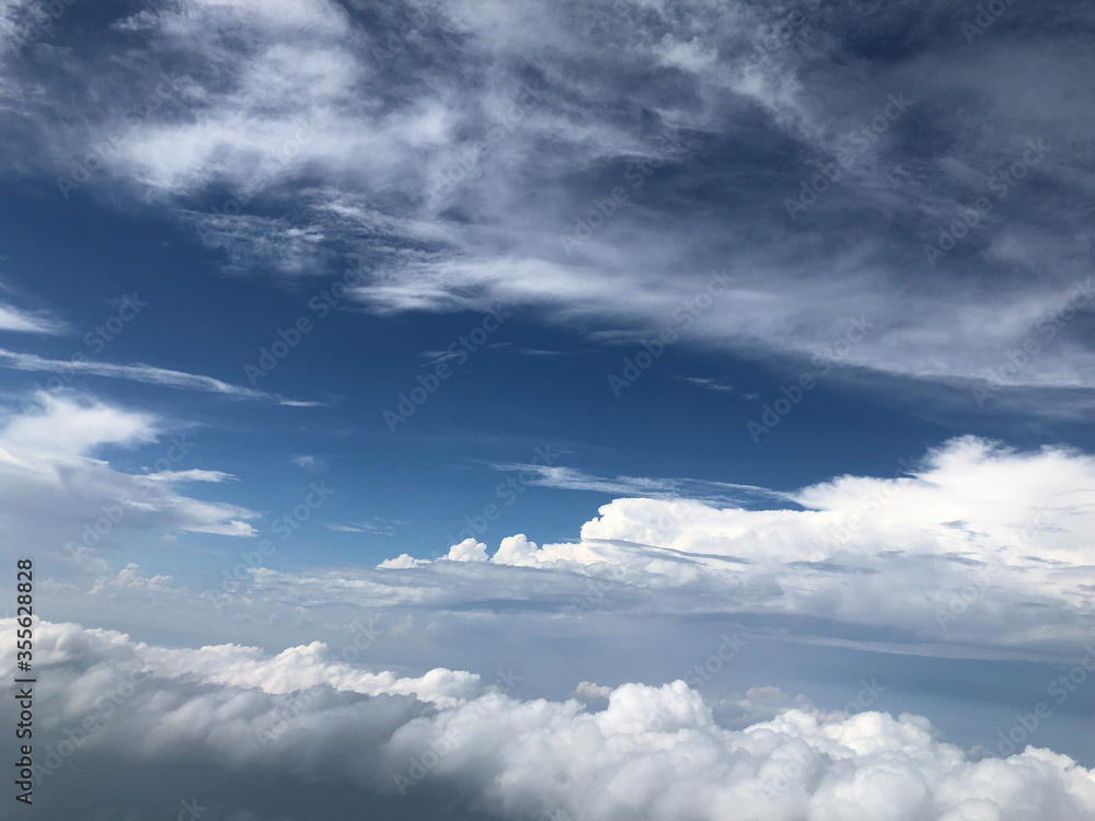 view of blue sky and white clouds flying by plane