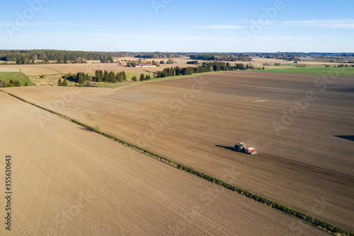 Aerial view of a tractor sowing wheat on agricultural field