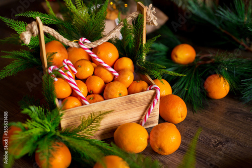 Christmas gingerbread cookies  tangerines  branches of a Christmas tree with garlands on a wooden background. A Christmas background with space for text. Happy Christmas morning.