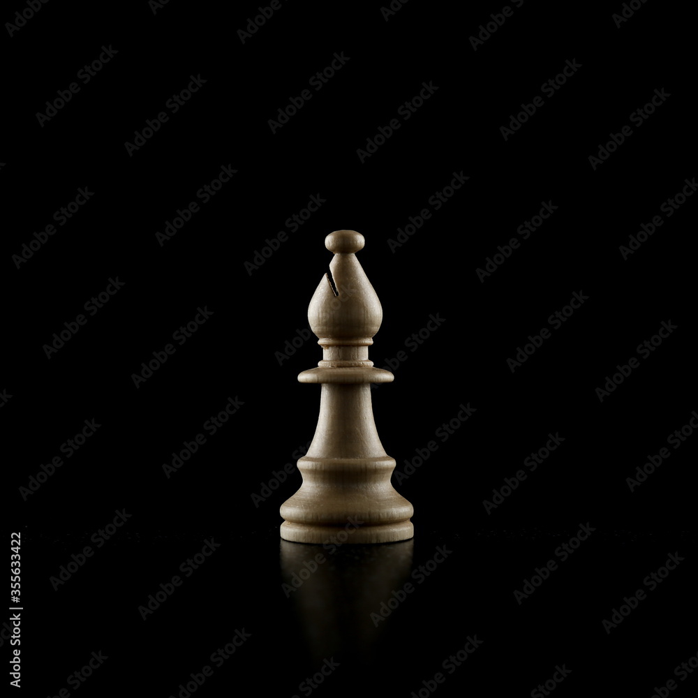 white chess piece on a black background white chess piece on a black background