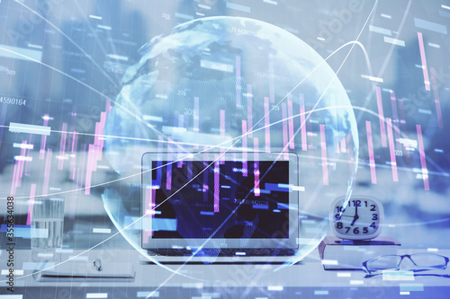 Stock market graph on background with desk and personal computer. Multi exposure. Concept of financial analysis.