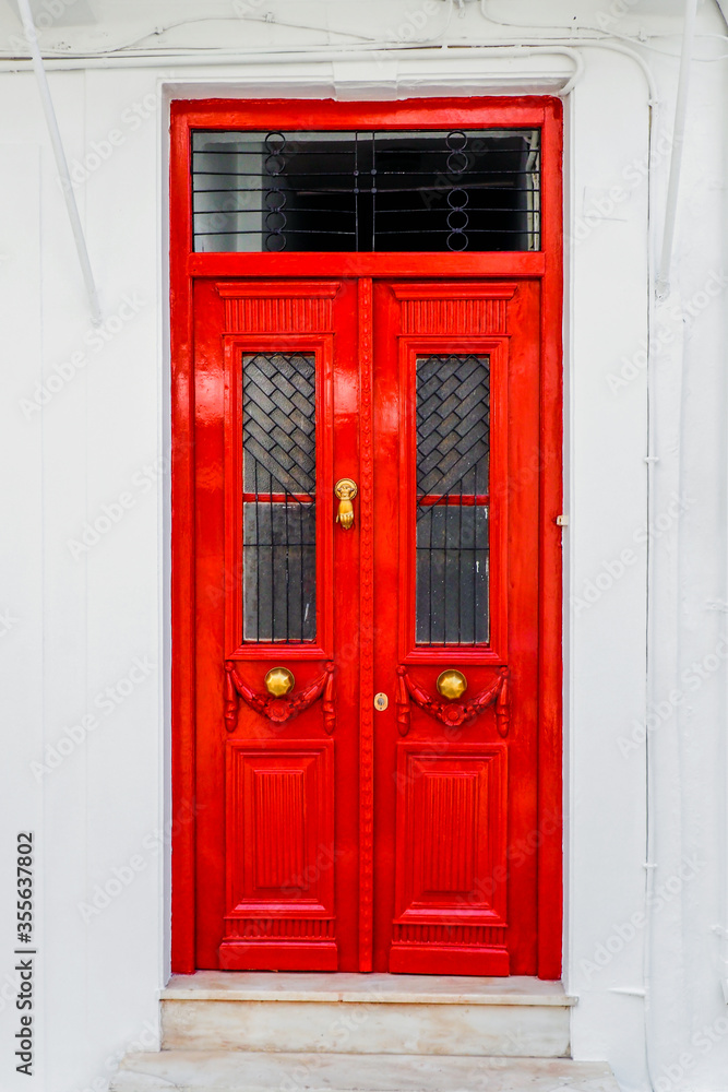the old and solid painted wooden doors are one of the charms of the magnificent Cyclades islands, in the heart of the Aegean Sea the old and solid painted wooden doors are one of the charms of the magnificent Cyclades islands, in the heart of the Aegean Sea