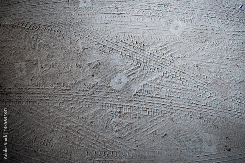 foot step and tire track on the sand ground abstract old background