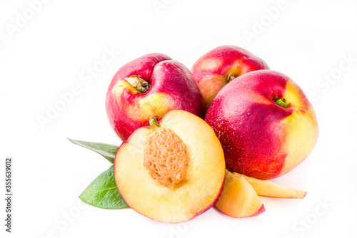 Raw whole and half sliced peaches. Fresh summer peaches fruits isolated on white background