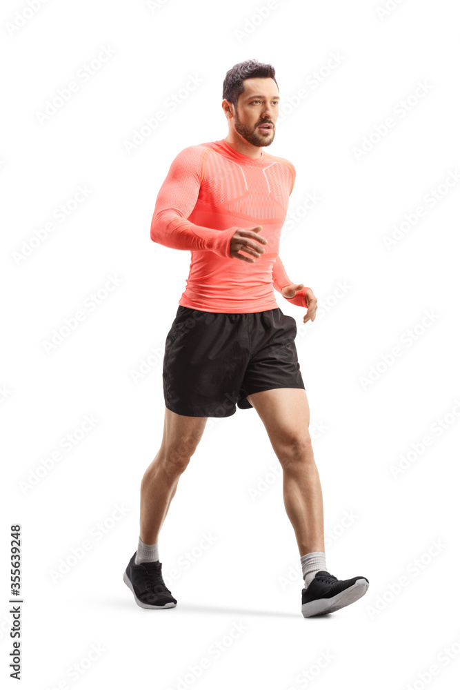 Fit young man in sportswear walking fast Fit young man in sportswear walking fast