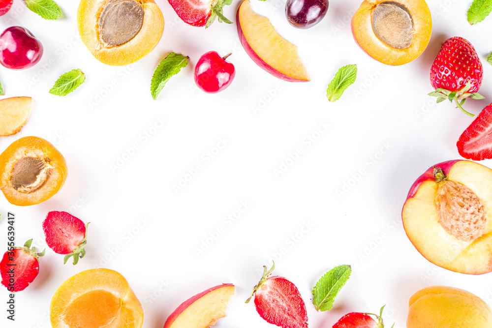 Summer background with fresh fruits and berries on white background. Set of various seasonal fruit and berry  - strawberry, apricots, peach slices, cherry, mint. Flat lay. Summer fruits concept.