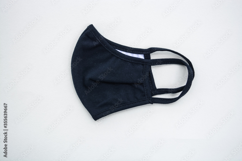 Single textile black medical face mask isolated on white background Single textile black medical face mask isolated on white background