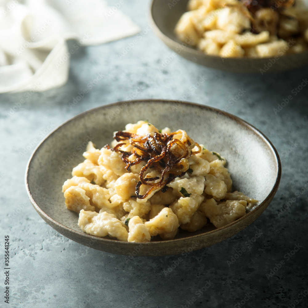 Traditional German noodles with cheese and fried onion Traditional German noodles with cheese and fried onion