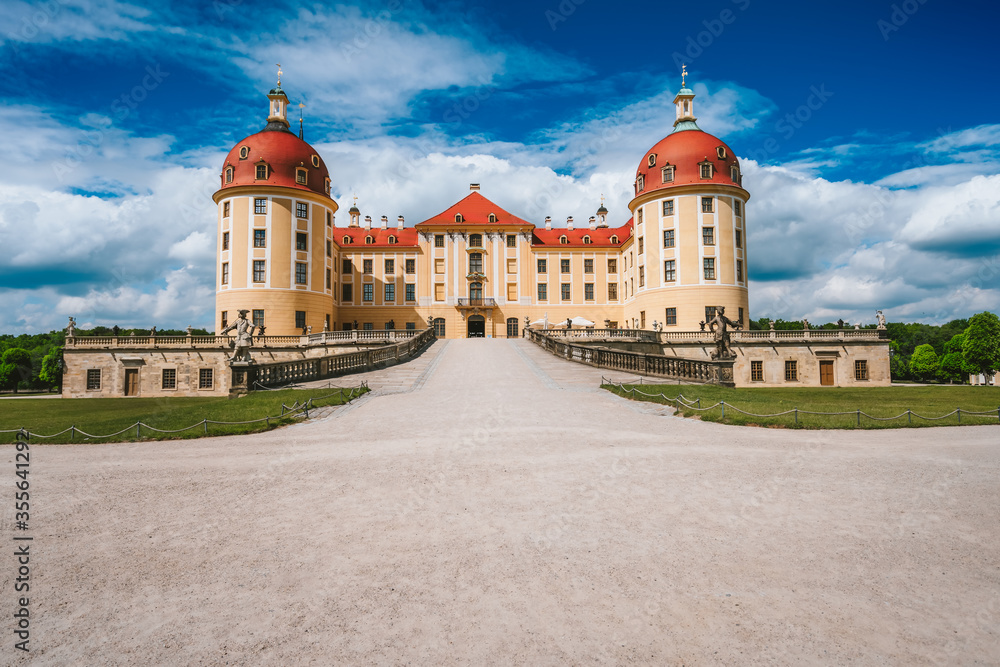 Castle Moritzburg located in Germany, Saxony region, near Dresden. Beautiful spring day with blue sky and white clouds. Surrounded by beautiful park
