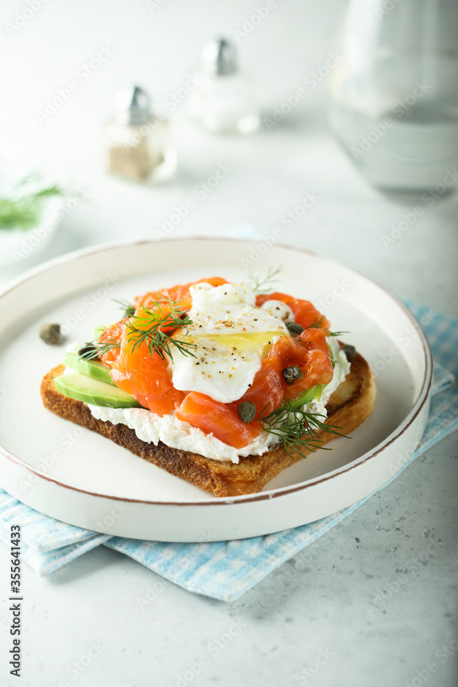 Poached egg with salmon and avocado on toast Poached egg with salmon and avocado on toast