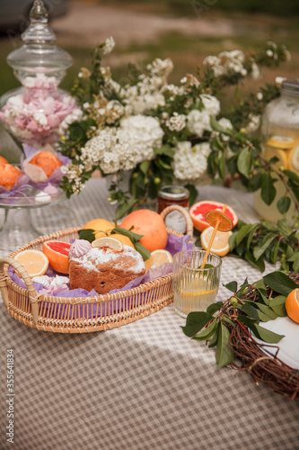 Muffins in a fruit basket. Picnic in the Park on the green grass with fruit  Lemonade