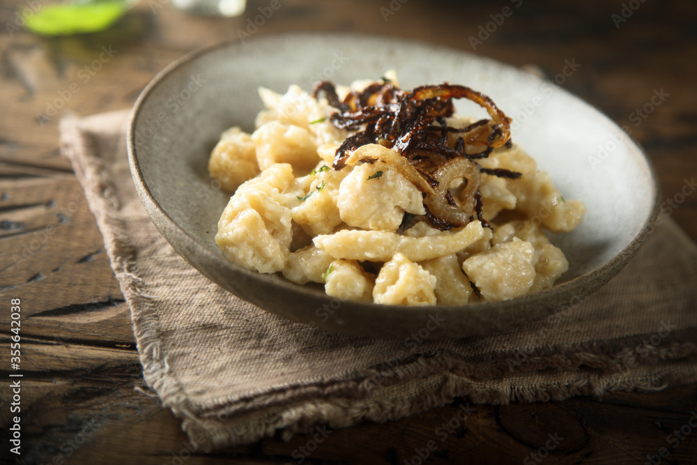 Traditional German noodles with cheese and fried onion Traditional German noodles with cheese and fried onion