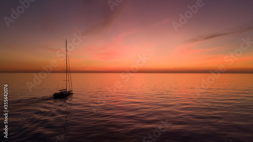 Superyacht sailing boat sunset over the sea © Glenn