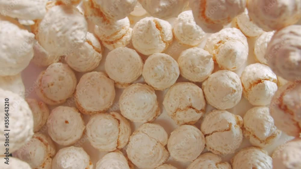 Sweet meringues pastries light pink peach colour counterclockwise rotation table top still life Sweet meringues pastries light pink peach colour counterclockwise rotation table top still life
