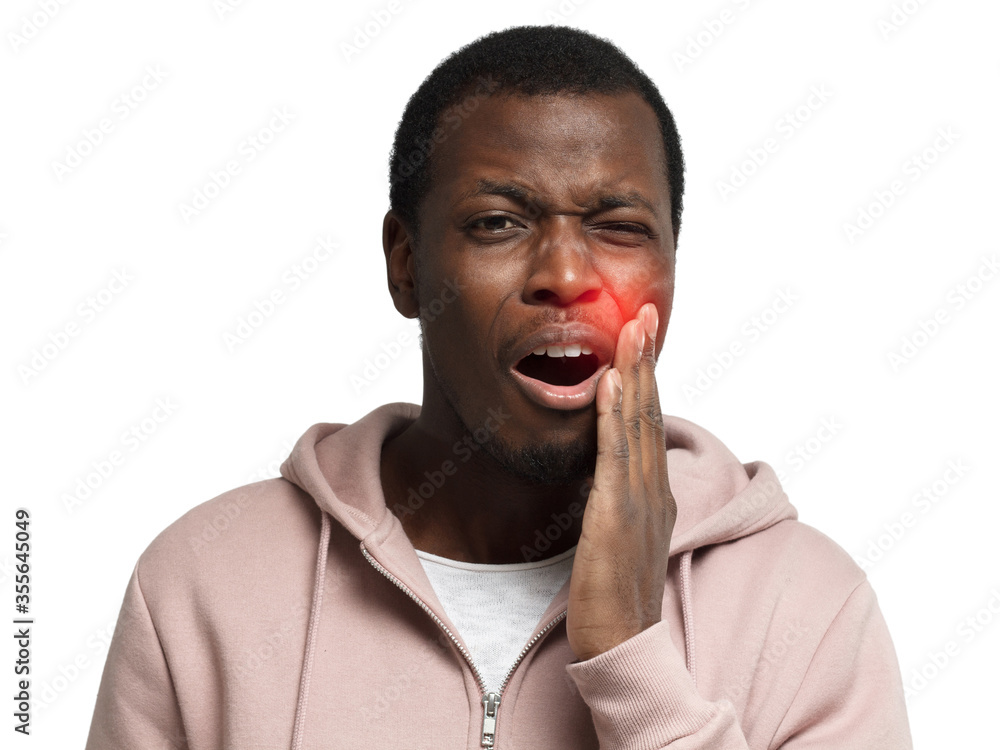 Toothache concept. Young african man with mouth open, touching his face with expression of horrible suffer from health problem and aching tooth, isolated on white background