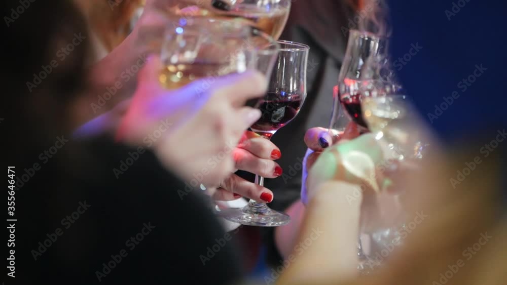 People with glasses of alcohol and glasses of wine celebrate. Hands of people with glasses of wine close-up. People with glasses of alcohol and glasses of wine celebrate. Hands of people with glasses of wine close-up.