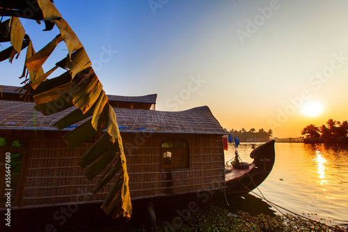 Kerala houseboat with banana palm on sunset, South India photo