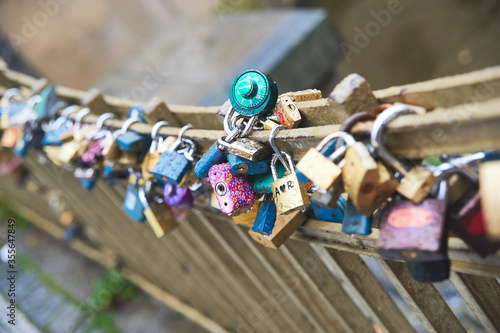 colorful love padlocks fastened on a bridge in Prague