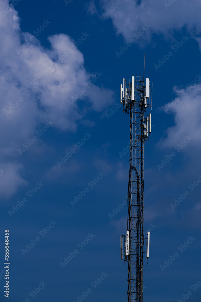 Telecommunication telephone signal transmission tower with beautiful blue sky and cloudy background Telecommunication telephone signal transmission tower with beautiful blue sky and cloudy background