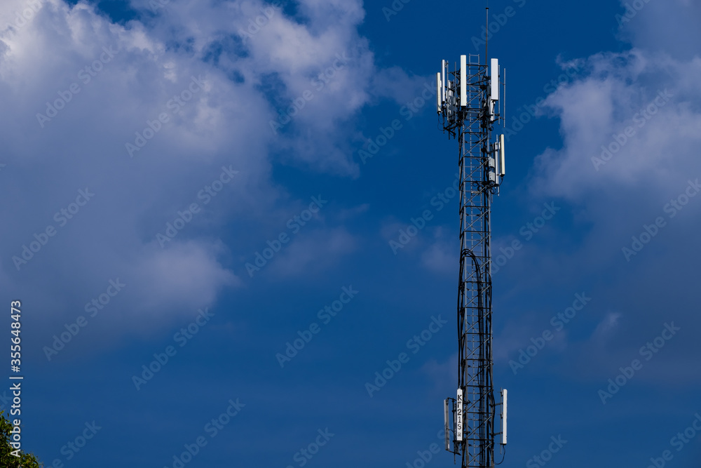 Telecommunication telephone signal transmission tower with beautiful blue sky and cloudy background Telecommunication telephone signal transmission tower with beautiful blue sky and cloudy background