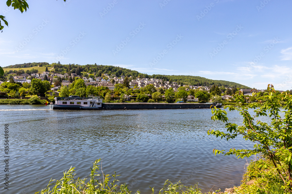 Idyllic view of the bank of the Moselle with cargo ship Idyllic view of the bank of the Moselle with cargo ship