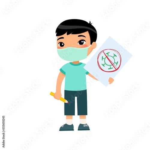 Little asian boy with medical mask holding paper sheet with virus image. Cute schoolkid with image and pencil in hands isolated on white background. Virus protection consept.