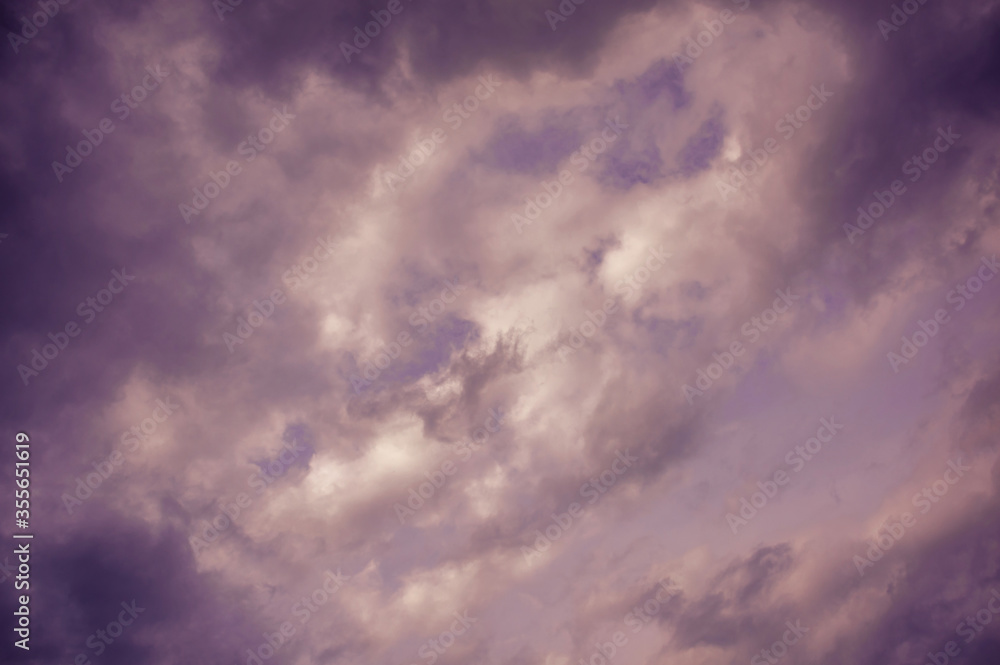 Natural sky composition. Dark ominous grey storm rain clouds. Dramatic sky. Overcast stormy cloudscape. Thunderstorm. Element of apocalypse design. Toned purple.