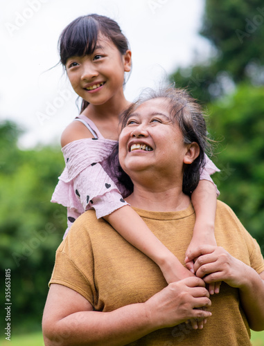 Grandmother and granddaughter enjoyed in the garden.Asian family conception